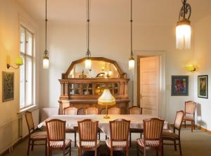 a dining room with a table and chairs and a mirror at Hotel Abel Pension Budapest in Budapest