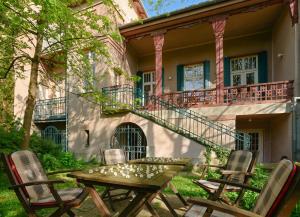 a patio with a table and chairs in front of a building at Hotel Abel Pension Budapest in Budapest
