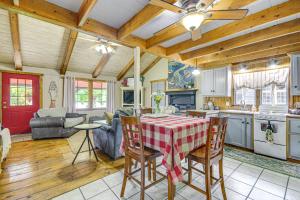 a kitchen and living room with a table and chairs at Hike, Swim and Fish Lakefront Cabin in Roach! in Roach