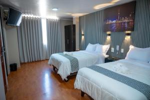Ένα ή περισσότερα κρεβάτια σε δωμάτιο στο Aparthotel Costal Sol Tacna +39 φωτογραφίες