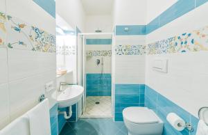 a blue and white bathroom with a toilet and a sink at Hotel Villa D'Orta in Casamicciola Terme +66 photos