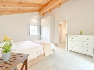 ein weißes Schlafzimmer mit einem Bett und einer Kommode in der Unterkunft Casa di montagna - Parcheggio gratuito - WiFi in Segno + 7 Fotos