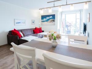 a living room with a table and a couch at Kaiserhof 18 Wohnung 16 in Kellenhusen