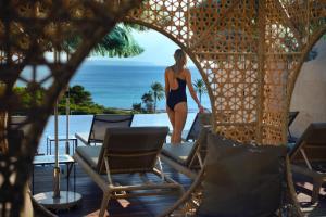 a woman in a black bikini is standing on a table at El Llorenc Parc de la Mar - Adults Only (+16) in Palma de Mallorca