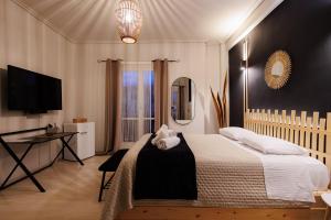 a bedroom with a bed and a desk and a television at Historical View in Kalamata
