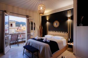 a bedroom with a large bed and a balcony at Historical View in Kalamata