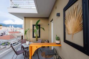 a room with a table and chairs on a balcony at Historical View in Kalamata
