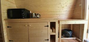 a tv on top of a wooden cabinet in a room at Camping Onlycamp Port Sainte Marie in Malicorne-sur-Sarthe