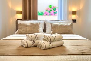 a bed with three folded towels on top of it at Apartments Sinisa - City of Krk in Krk