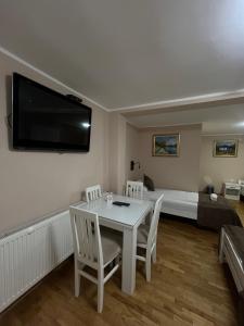 a room with a table and chairs and a bed at Babiko DTM 037 in Čitluk +16 photos
