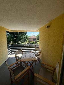 a table and chairs on a balcony with a view at Babiko DTM 037 in Čitluk