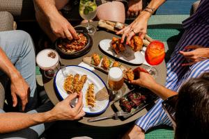 a group of people sitting around a table eating food at El Llorenc Parc de la Mar - Adults Only (+16) in Palma de Mallorca