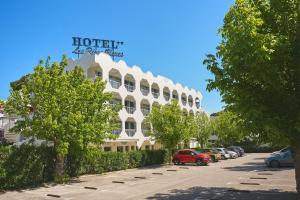 a hotel building with a sign on top of it at Hôtel Les Rives Bleues in La Grande Motte