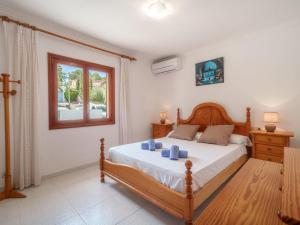 a bedroom with a bed and a window at Holiday Home Lisboa by Interhome in Cala Murada
