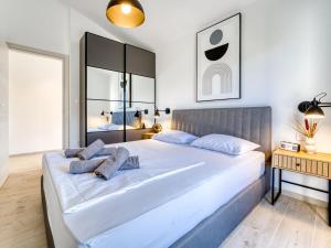 a bedroom with a large white bed with blue pillows at Holiday Home Domagoj by Interhome in Malinska