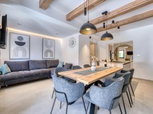 a kitchen and living room with a wooden table and chairs at Holiday Home Domagoj by Interhome in Malinska
