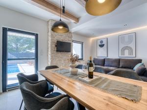 a dining room with a table and a couch at Holiday Home Domagoj by Interhome in Malinska +37 photos
