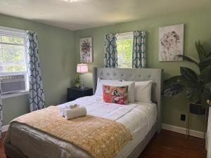 a bedroom with a large bed with green walls at Cozy Home in New Britain