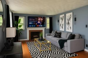 a living room with a couch and a tv at Cozy Home in New Britain