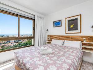 a bedroom with a bed and a large window at Apartment O-House by Interhome in Torremolinos