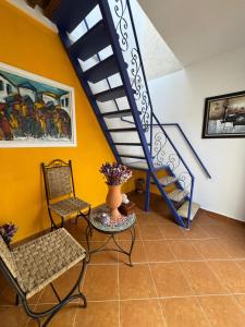 un soggiorno con una scala, un tavolo e delle sedie di Riad Radia a Rabat