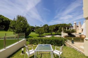 a patio with two chairs and a table in a yard at Vale Do Lobo Resort in Vale do Lobo
