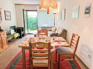 a living room with a dining room table and chairs at Apartment Sonnenmatt App- 12 by Interhome in Höchenschwand
