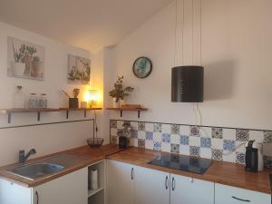 a kitchen with a sink and a counter top at Ático Vista La Sierra in Jarandilla de la Vera