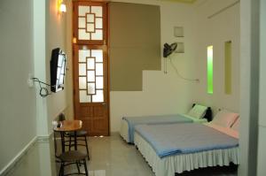 Tempat tidur dalam kamar di Bien Khoi Mini Hotel