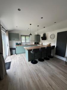 a kitchen with a large island in the middle of a room at Sunset Retreat in Three Legged Cross +33 photos
