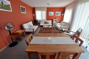 a living room with a table and chairs at Mimas Garden Apartments in Karaburun