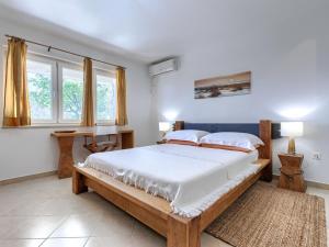 a bedroom with a large bed and a window at Holiday Home Nira by Interhome in Rabac