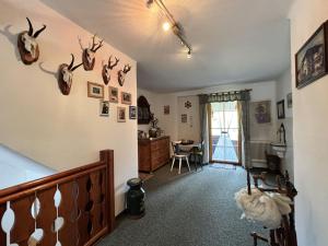 a living room with antlers hanging on the wall at Apartment Ferienwohnung Christoph by Interhome in Haus im Ennstal