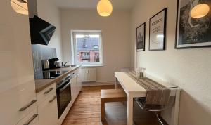 a small kitchen with a table and a counter top at Apartment Küstenkoje I in Rostock