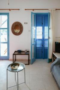 a living room with a blue door and a table at L'Azure 24 - Protaras in Paralimni