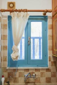 a blue window above a sink in a kitchen at L'Azure 24 - Protaras in Paralimni