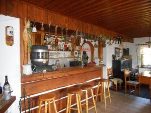 a bar with wooden bar stools in a room at Horský Ranč in Pec pod Sněžkou