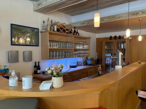 a bar with a counter with bottles of wine at Schatzn Hof Landgasthaus in Pottenstein