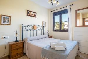 a bedroom with a large bed and a window at coto 2 14 in Chiclana de la Frontera +19 photos