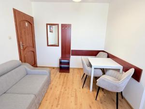 a living room with a couch and a table at Albatros PRZY PLAŻY in Władysławowo