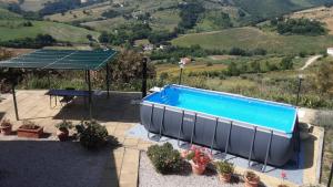 a swimming pool with a table and a picnic table at Casa Adriana in Penne