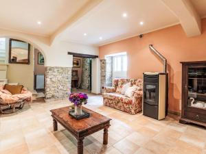 a living room with a fireplace and a table at Apartment Casa Derna by Interhome in Pietrabuona