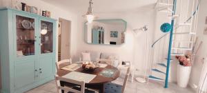 a dining room with a table and a mirror at La casa Rosa 2 in Ponza +14 photos