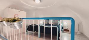 a bedroom with a crib with two potted plants on it at La casa Rosa 2 in Ponza