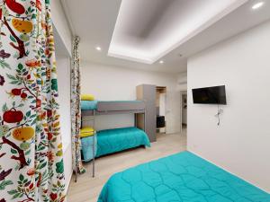 a bedroom with a bunk bed and a tv at Ilaria e Giulia Rooms in Corbara