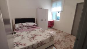 a small bedroom with a bed and a white cabinet at Homestay 641 Mu5lim only in Port Dickson