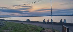 a group of people standing on a dock near the water at Thistle & Tide in Edinburgh