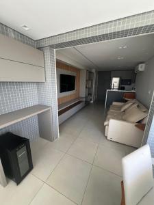 a large room with a bed and a tv in it at Stella Maris Premium in Salvador