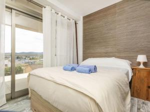 a bedroom with a bed with two blue towels on it at Apartment Ambassador by Interhome in Peñíscola