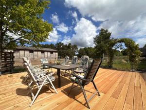 a patio table and chairs on a wooden deck at Eickhof Ferienzimmer No2 mit Bad, Parkplatz - Ferienhof Günter in Warnow
